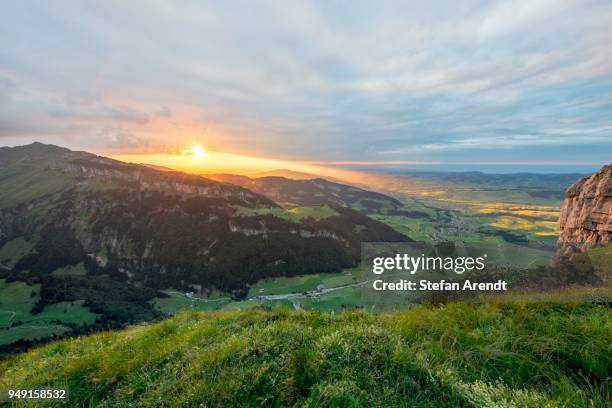 dramatic sunset with cloudy skies in the mountains on the alpsigel in alpstein, bruelisau, appenzell innerrhoden, switzerland - appenzell innerrhoden stock pictures, royalty-free photos & images
