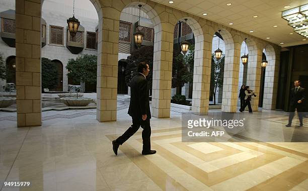 Syrian President Bashar al-Assad walks towards Lebanese Prime Minister Saad Hariri upon the latter's arrival for a meeting in Damascus on December...