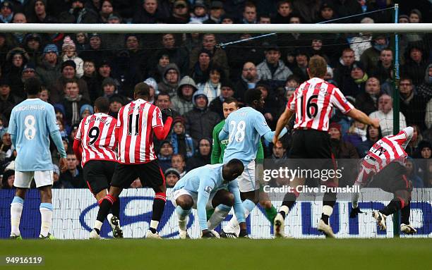 John Mensah of Sunderland scores his team's first goal during the Barclays Premier League match between Manchester City and Sunderland at the City of...