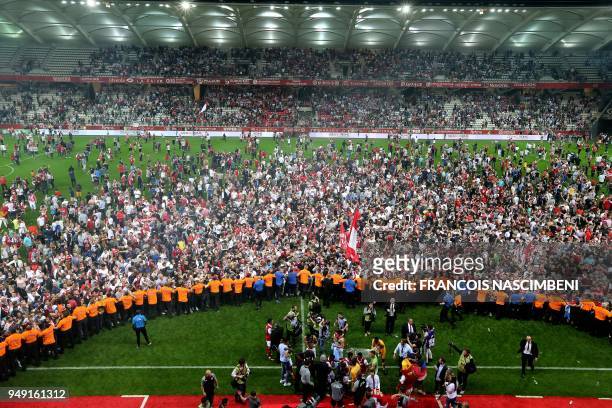 Reims' supporters celebrate after Stade de Reims won and got promoted to the Ligue 1 after the Ligue 2 Football match Reims-Ajaccio on April 20, 2018...