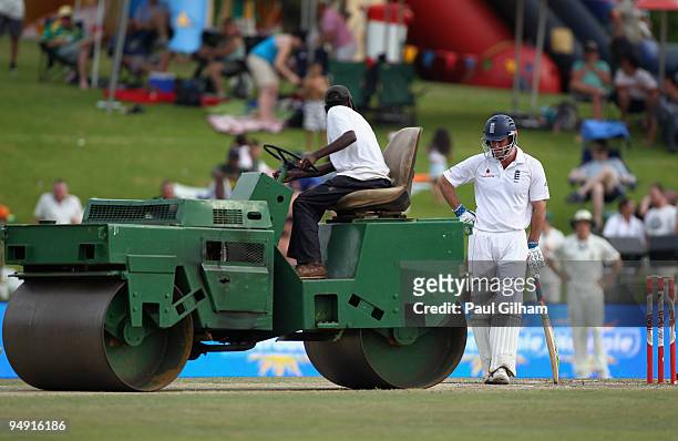 Andrew Strauss of England looks at the wicket while he waits to bat as ground staff use the roller during day four of the first test match between...