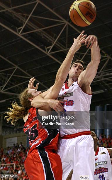 Luke Schenscher of the Wildcats and Matthew Burston of the 36'ers contest a rebound during the round 13 NBL match between the Perth Wildcats and the...