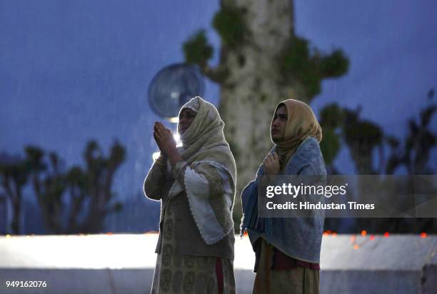 People pray as a relic is displayed at the Hazratbal shrine following the Muslim festival of Mehraj-u-Alam, the anniversary of the day on which many...