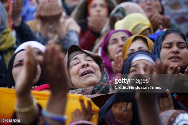 People pray as a relic is displayed at the Hazratbal shrine following the Muslim festival of Mehraj-u-Alam, the anniversary of the day on which many...
