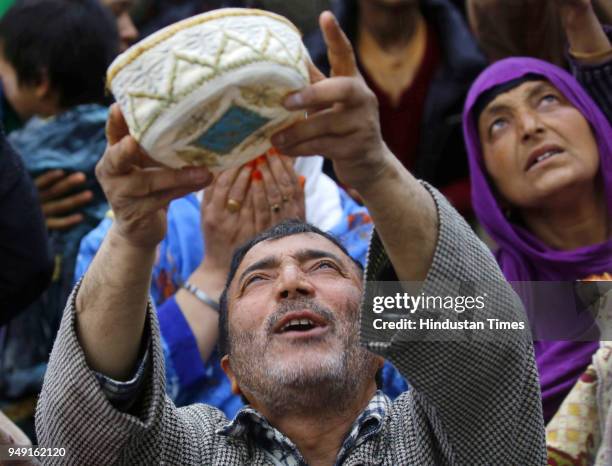 People pray as a relic is displayed at the Hazratbal shrine following the Muslim festival of Mehraj-u-Alam, the anniversary of the day on which many...