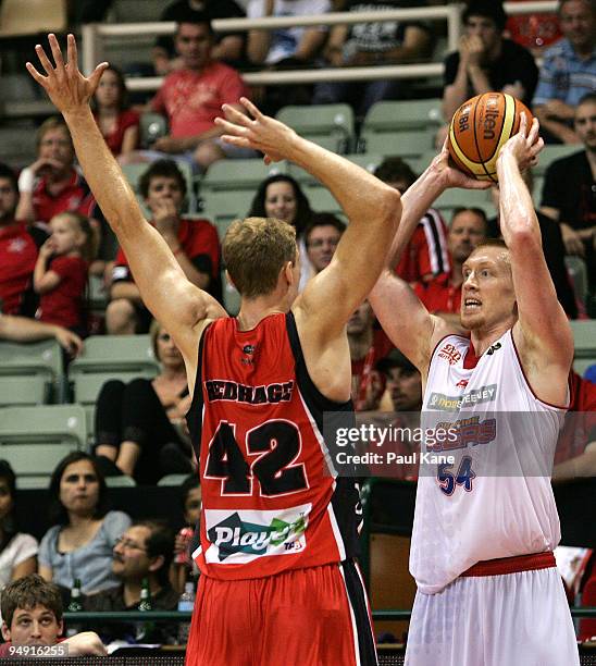 Adam Ballinger of the 36'ers looks to in-bound the ball past Shawn Redhage of the Wildcats during the round 13 NBL match between the Perth Wildcats...