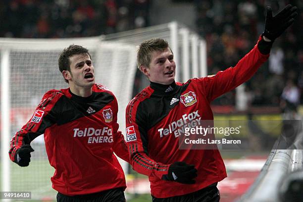 Toni Kroos of Leverkusen celebrates scoring his teams third goal with team mate Tranquillo Barnetta during the Bundesliga match between Bayer...