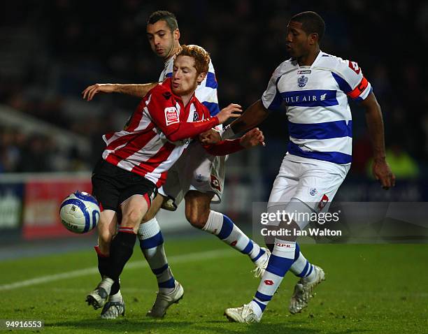 Mikele Leigertwood of QPR tries to tackle Stephen Quinn of Sheffield United during the Coca Cola Championship match between Queens Park Rangers and...