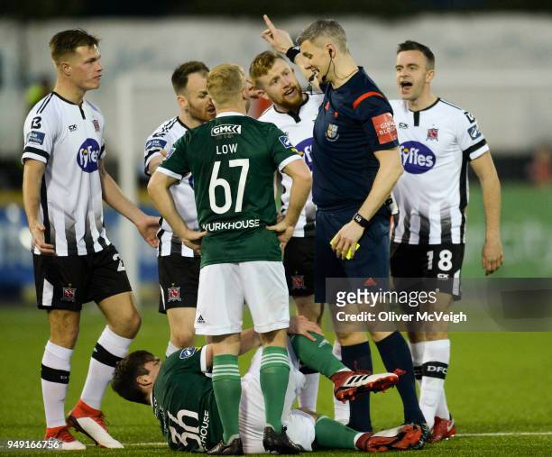 Dundalk , Ireland - 20 March 2018; Referee Ben Connolly surrounded by players from both sides after an incident during the SSE Airtricity League...