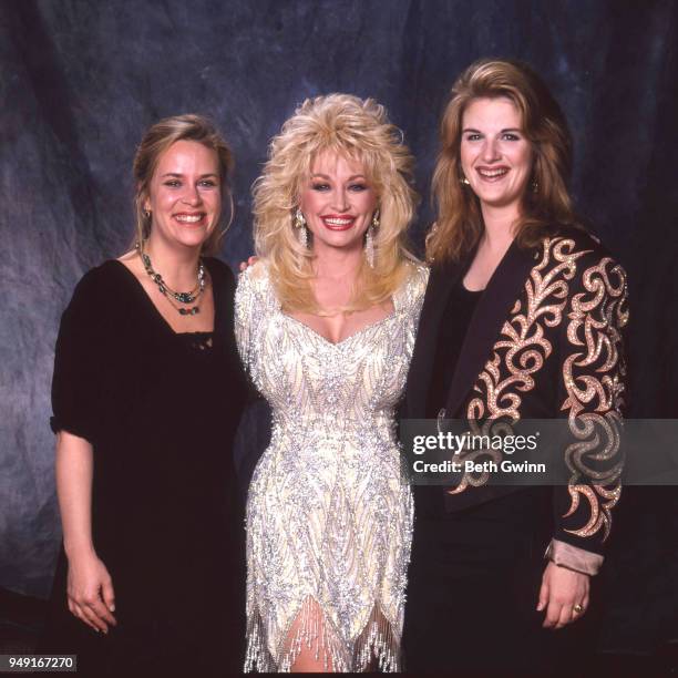 Country singer and songwriter Dolly Parton poses with Mary Chapin Carpenter, and Tricia Yearwood backstage the CMA Award Show Backstage October 10,...