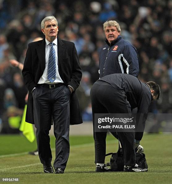 Manchester City's Welsh manager Mark Hughes watches a replay of... News