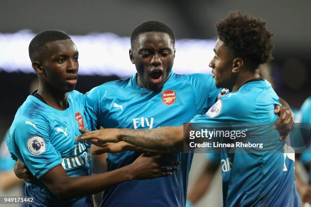 Edward Nketiah of Arsenal celebrates with teammates Josh Dasilva and Reiss Nelson after scoring his sides third goal during the Premier League 2...