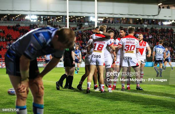St Helens' Danny Richardson celebrates after scoring a try behind a dejected Huddersfield Giants' Lee Gaskell during the Betfred Super League match...