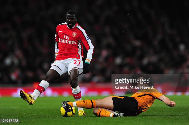 Emmanuel Eboue of Arsenal is tackled by Stephen Hunt of Hull during the Barclays Premier League match between Arsenal and Hull City at the Emirates...