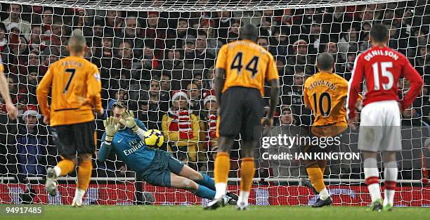 Arsenal's Spanish goalkeeper Manuel Almunia saves a penalty from Hull City's Brazilian player Geovanni during the English Premier League football...