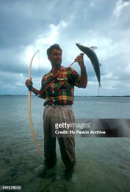 Colyn Rees holds up the fish he shot with his bow and arrow while bone fishing on April 7, 1956 in the Bahamas.