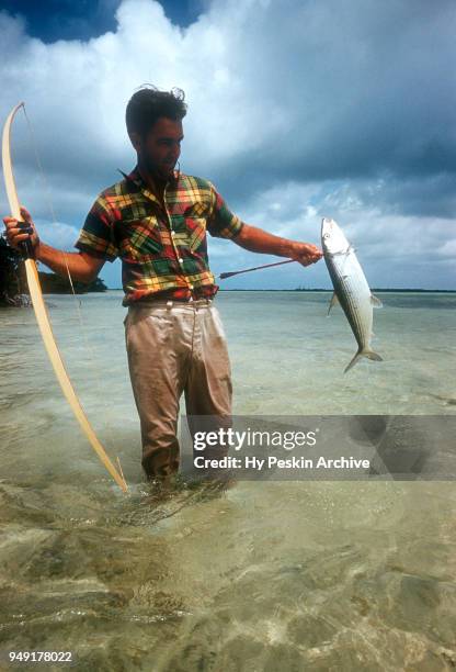 Colyn Rees holds up the fish he shot with his bow and arrow while bone fishing on April 7, 1956 in the Bahamas.