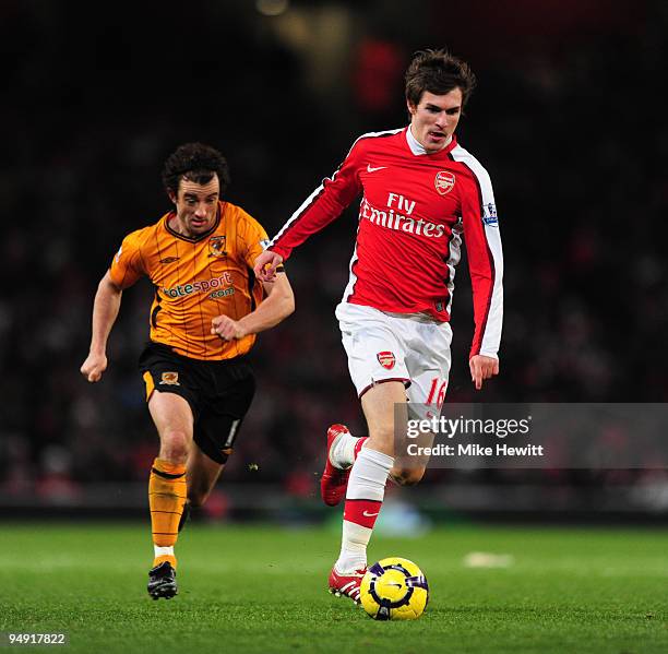 Aaron Ramsey of Arsenal beats Stephen Hunt of Hull during the Barclays Premier League match between Arsenal and Hull City at the Emirates Stadium on...