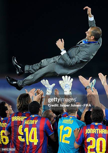 Head coach Josep Guardiola of FC Barcelona is thrown in the air by players after winning the Club World Cup Final match against Estudiantes at the...