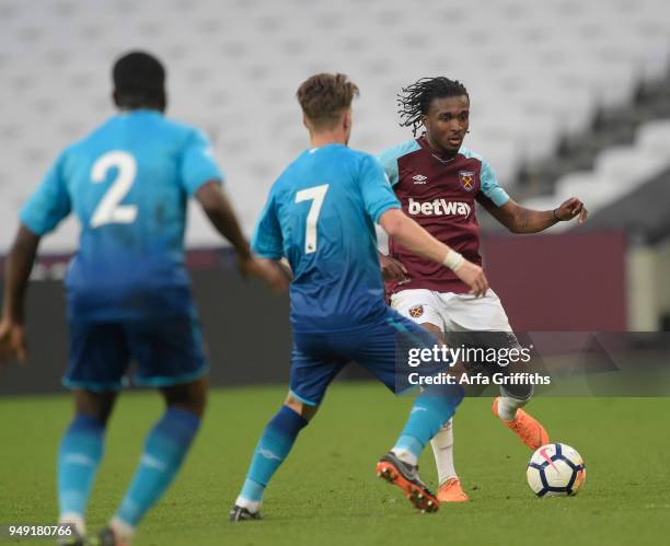 Vashon Neufville of West Ham United in action with Vlad Dragomir and Jordi Osei-Tutu during the Premier League 2 match between West Ham United and...