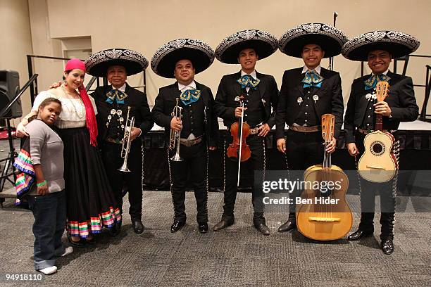 Mariachi band visit the New Yorkers for Children face painting booth at the Jacob Javitz Center on December 19, 2009 in New York City.