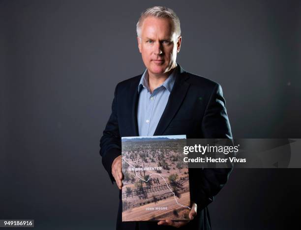 Photographer John Moore poses with his book Undocumented during the launch event of Undocumented book at WeWork Varsovia Building on April 19, 2018...