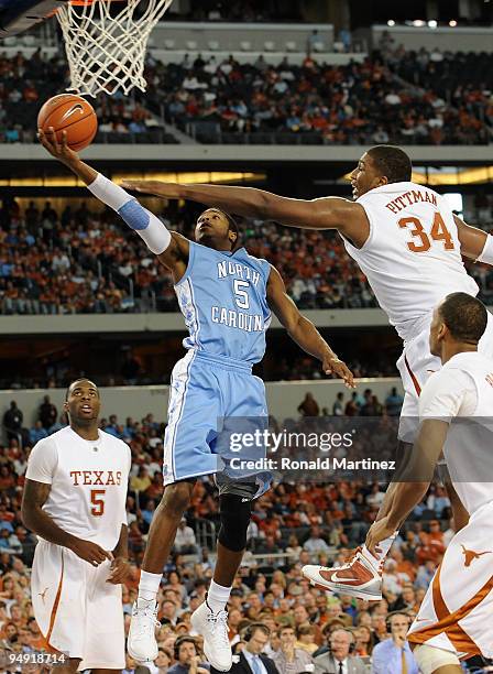 Dexter Strickland of the North Carolina Tar Heels takes a shot against Dexter Pittman of the Texas Longhorns at Cowboys Stadium on December 19, 2009...