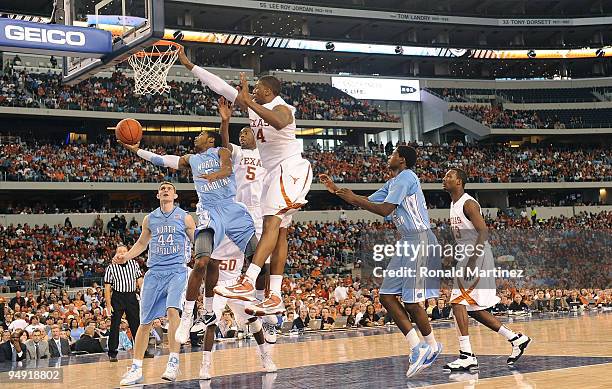 Dexter Strickland of the North Carolina Tar Heels takes a shot against Dexter Pittman of the Texas Longhorns at Cowboys Stadium on December 19, 2009...