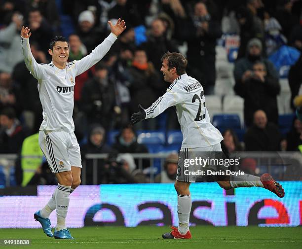 Cristiano Ronaldo of Real Madrid celebrates with fellow goalscorer Rafael Van Der Vaart after scoring the 5:0 goal during the La Liga match between...