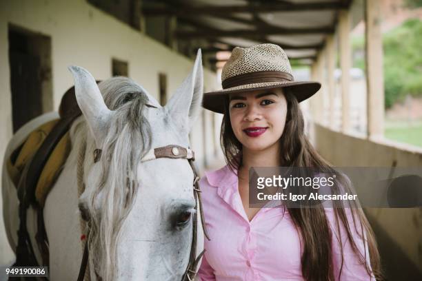 cowgirl und die kruppe pferd im stall - manga larga stock-fotos und bilder
