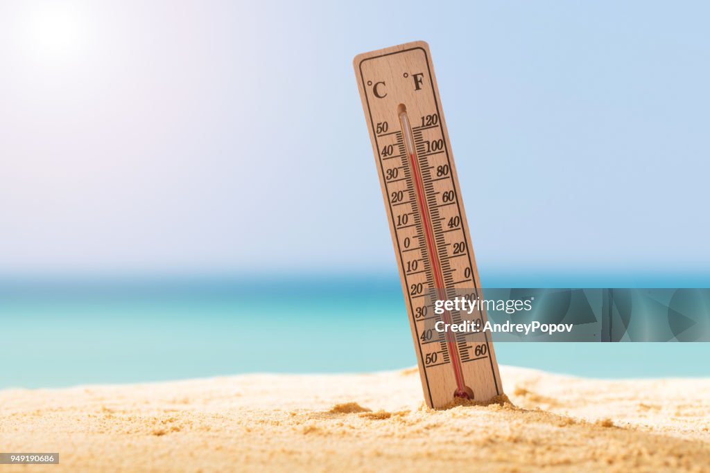 Close-up Of Thermometer On Sand