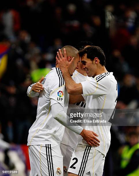 Karim Benzema of Real Madrid celebrates his goal with Alvaro Arbeloa and Cristiano Ronaldo during the La Liga match between Real Madrid and Real...