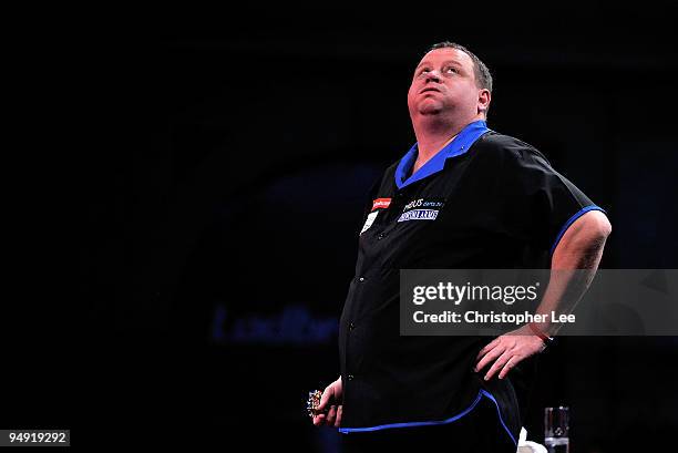 Andy Jenkins of England blows out his cheeks as he plays against Peter Manley of England during the 2010 Ladbrokes.com World Darts Championship Round...