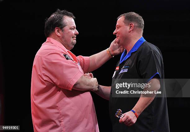 Peter Manley of England and Andy Jenkins of England shake hands after Manley wins during the 2010 Ladbrokes.com World Darts Championship Round One at...