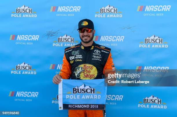 Martin Truex Jr., driver of the Bass Pro Shops/5-hour ENERGY Toyota, poses with the Busch Pole Award after qualifying in the pole position for the...