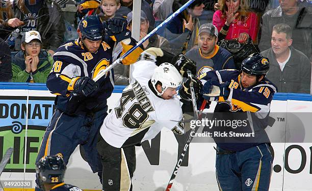 Paul Gaustad and Tim Connolly of the Buffalo Sabres check Tyler Kennedy of the Pittsburgh Penguins at HSBC Arena on December 19, 2009 in Buffalo, New...