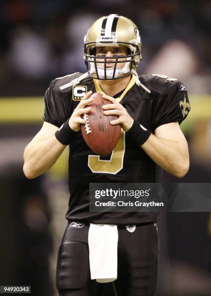 Quarterback Drew Brees of the New Orleans Saints warms-up before taking on the Dallas Cowboys at Louisiana Superdome on December 19, 2009 in New...