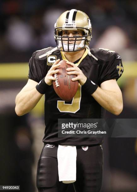 Quarterback Drew Brees of the New Orleans Saints warms-up before taking on the Dallas Cowboys at Louisiana Superdome on December 19, 2009 in New...