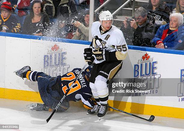 Jason Pominville of the Buffalo Sabres loses an edge as he tried to check Sergei Gonchar of the Pittsburgh Penguins at HSBC Arena on December 19,...