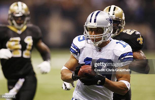 Miles Austin of the Dallas Cowboys runs after making a catch to score a 49-yard touchdown in the first quarter against the New Orleans Saints at the...