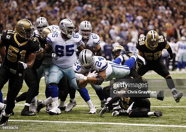 Marion Barber of the Dallas Cowboys dives into the endzone for a three-yard touchdown in the first quarter against the New Orleans Saints at...