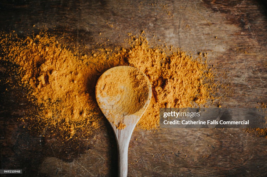 Turmeric Powder on a wooden spoon