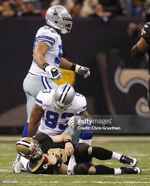 Quarterback Drew Brees of the New Orleans Saints is sacked by Anthony Spencer of the Dallas Cowboys for a 10-yard loss in the first half at Louisiana...
