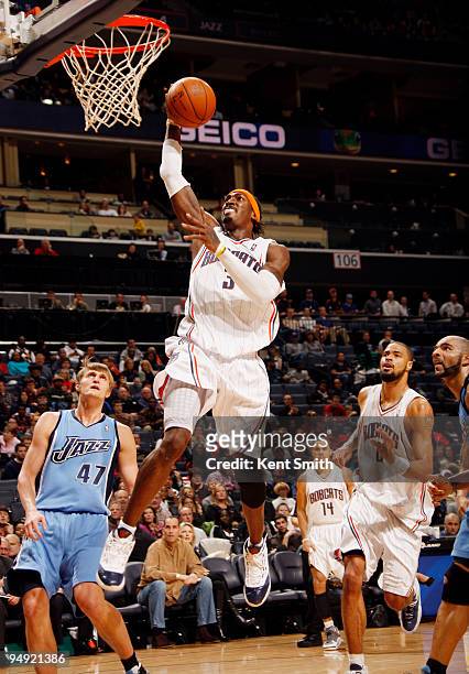 Gerald Wallace of the Charlotte Bobcats goes to the basket against C.J. Miles of the Utah Jazz on December 19, 2009 at the Time Warner Cable Arena in...