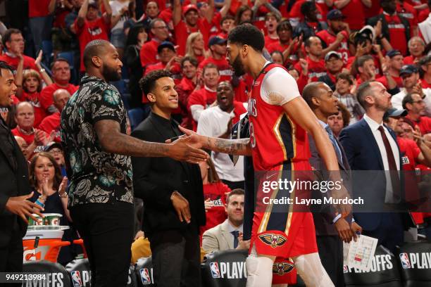 Anthony Davis of the New Orleans Pelicans high-fives DeMarcus Cousins of the New Orleans Pelicans during the game against the Portland Trail Blazers...