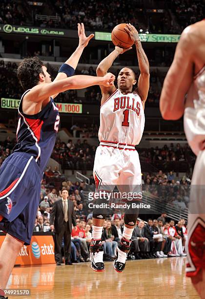 Derrick Rose of the Chicago Bulls shoots a jumper over Zaza Pachulia of the Atlanta Hawks during the NBA game on December 19, 2009 at the United...