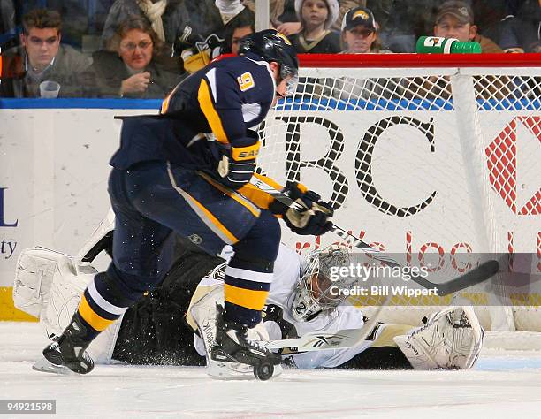 Marc-Andre Fleury of the Pittsburgh Penguins makes a poke-check shootout save against Derek Roy of the Buffalo Sabres on December 19, 2009 at HSBC...