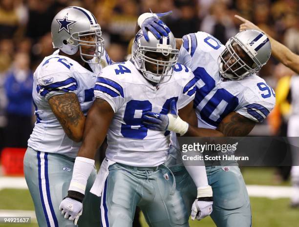 Linebacker DeMarcus Ware of the Dallas Cowboys celebrates with defensive ends Jay Ratliff and Stephen Bowen after a sack against the New Orleans...