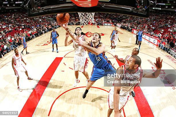 Nenad Krstic of the Oklahoma City Thunder shoots the ball over Shane Battier of the Houston Rockets on December 19, 2009 at the Toyota Center in...