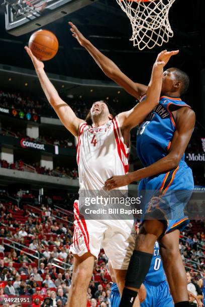 Luis Scola of the Houston Rockets shoots the ball over Kevin Durant of the Oklahoma City Thunder on December 19, 2009 at the Toyota Center in...